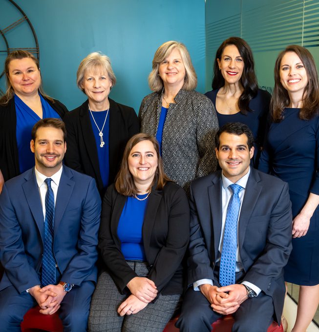 Eight smiling financial advisors at the Middleburg Financial Branch