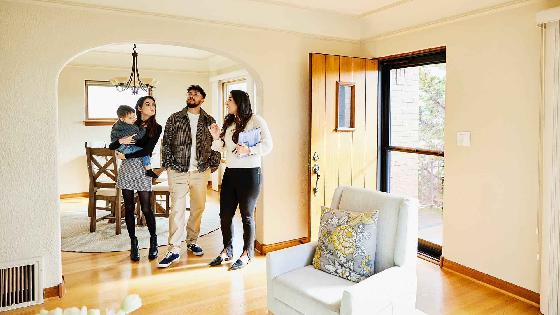 Family inside a home with a real estate agent